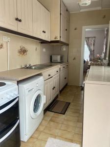 a kitchen with a washer and dryer in it at Sunrise Cottage in Killybegs