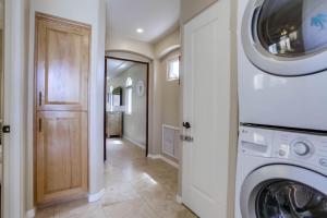 a laundry room with a washer and dryer at Stunning Ocean View Home w Rooftop Terrace, Firepit, Fast Wifi, AC & Parking! in San Diego