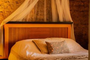a bedroom with a bed with a canopy at Casa Fuente en el Corazón Cultural de Guadalajara in Guadalajara