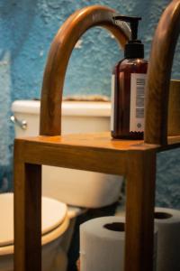 a bathroom with a toilet and a bottle of soap at Casa Fuente en el Corazón Cultural de Guadalajara in Guadalajara +18 photos