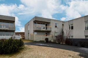 an apartment building with a driveway in front of it at Kopavogur Cozy Nest (3-bedrooms) in Reykjavík