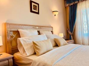 a bedroom with a bed with white pillows at Kishni, peaceful and luxury suite villa in Arrecife