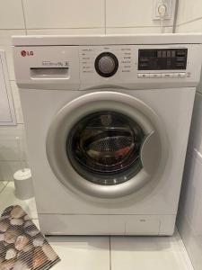 a white washing machine sitting in a kitchen at Rezekne Cozy Stay in Rēzekne