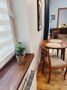 a small dining room with a table and chairs at City Center Apartments in Vilnius