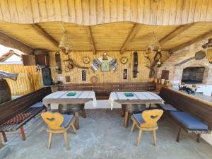 a dining room with two tables and chairs in it at Casa Bobo 10 in Bobohalma