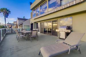 a patio with a table and chairs on a house at Mission Bay Dreams - w Bay Access, Parking, Pool & Spa in San Diego