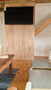 a living room with a couch and a television on a wall at Juanillo's ll in Punta Del Diablo