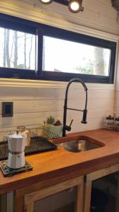 a kitchen counter with a sink and a window at Juanillo's ll in Punta Del Diablo