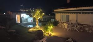 a view of a yard at night with christmas lights at Villa Noah in Moralet