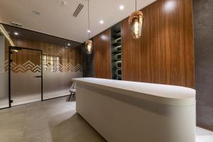 a wine tasting room with a large white tub at KOPAONIK WOODSIDE 58,70 m2 FREE Parking in Kopaonik +24 photos