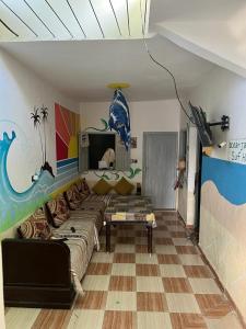 a living room with a couch and a table at Ocean Jam Surf House in Agadir