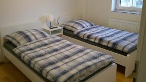 two twin beds in a room with at Unseburg-Ferienwohnung 4 