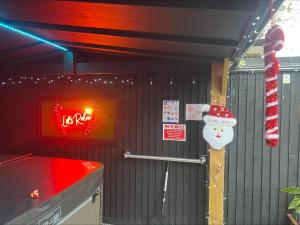 a restaurant with a santa hat on the wall at Hot tub, 110Inch Outdoor Cinema, Fire Pit, 4 Acre garden, Luxury 5 Star Woodland Lodge in Skegness