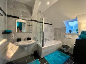 a bathroom with a sink and a tub and a toilet at Villa am Grossen Garten in Dresden +64 photos