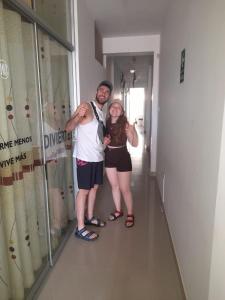 a man and a woman standing in a hallway at Hospedaje EL MARQUEZ Expat in Máncora