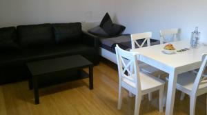 a living room with a couch and a table and a bed at Unseburger Brauhaus GmbH FW 4 in Unseburg