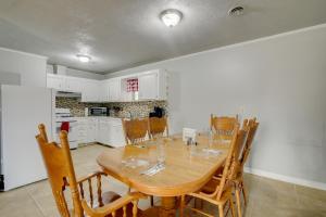 a kitchen and dining room with a wooden table and chairs at Family Vacation Rental Home Near Mississippi River in Osceola