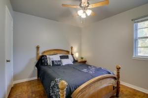 a bedroom with a bed with a ceiling fan at Family Vacation Rental Home Near Mississippi River in Osceola