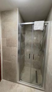 a shower with a glass door in a bathroom at Les Comtes de Savoie - Appartement rénové proche du centre de Megève avec vue sur le Mont d'Arbois in Megève