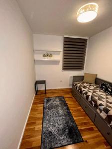 a living room with a bed and a window at Pale Green in Pale