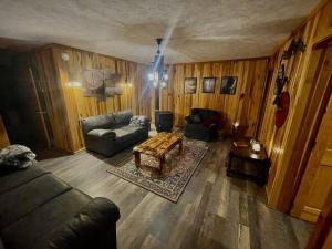 a living room with a couch and a table at Getaway to a very private beautiful Cabin. in Kyles Ford