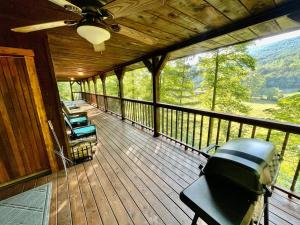 a screened in porch with a view of the mountains at Getaway to a very private beautiful Cabin. in Kyles Ford