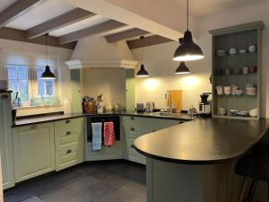 a large kitchen with a large island in it at Fisherman's Cottage - Surf Retreat in Wijk aan Zee