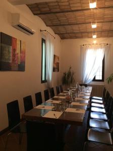 a large long table in a room with chairs at Corte Dossello in Migliaro