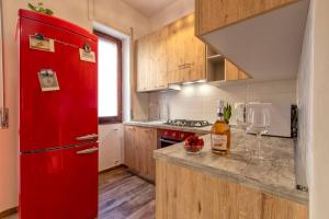 a red refrigerator in a kitchen with a counter at BoHo by the Beach in Alghero
