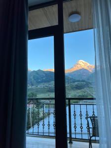 a room with a window with a view of mountains at Highland Kazbegi in Stepantsminda