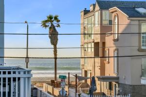 a view of the beach from between buildings at Beautiful Beach Home - Ocean View, AC & Patio in San Diego