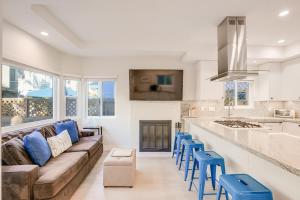 a living room with a couch and some blue stools at Beautiful Beach Home - Ocean View, AC & Patio in San Diego
