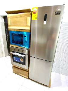 a stainless steel refrigerator and an oven in a kitchen at Ryan’s Apartment 
