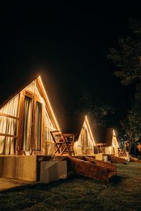 a cabin at night with lights on it at Pousada Vale da Neblina in Ubajara