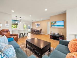 a living room with couches and a table and a dining room at Bay Park Garden Paradise - central Location, AC, Washer Dryer & Private yard! in San Diego