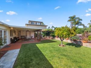 a backyard with a lawn and a house at Bay Park Garden Paradise - central Location, AC, Washer Dryer & Private yard! in San Diego
