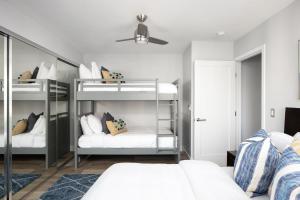 a bedroom with two bunk beds and a ceiling at Oceanfront, two-level condo with stunning view, decks, fast WiFi & fireplace in San Diego