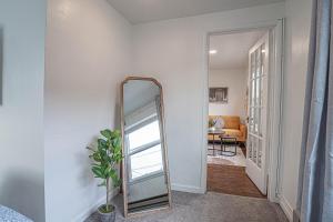 a mirror in a hallway next to a living room at Seaside Serenity 1-BR Apt with peek-a-boo sound views in Seattle