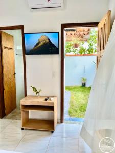a room with a door with a view of a mountain at Pousada Grão de Areia in Búzios
