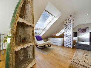 an attic room with a wooden shelf and a bedroom at große, elegante Ferienwohnung in Langenfeld