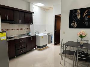 a kitchen with a sink and a table with a dining room at Amplio, comodo central Apto 1 in Apartadó