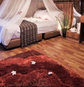 a bedroom with a bed and a red rug at Bintan Brzee Beach in Bintan Island - Bungalow 1 in Berakit