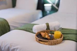 a basket of bread and a glass of orange juice on a bed at Apartment in Warwick - Families - Business - Contractors in Warwick
