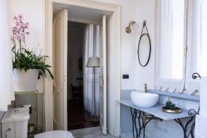a bathroom with a sink and a mirror at L'Angolo di Casa Verrua in Turin +37 photos