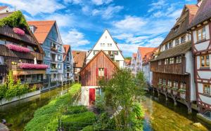 a group of buildings next to a river at Hotel Gasthof Rössle in Senden