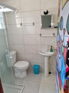 a bathroom with a toilet and a sink at Ohana's Flat Maresias in São Sebastião +32 photos