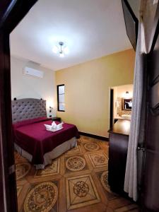 a hotel room with a bed and a dresser at La Mansión del Gran Jaguar in Retalhuleu