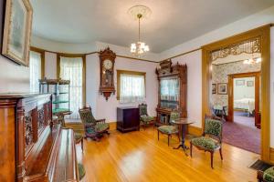a living room with a clock and a table and chairs at Lodi Hill House in Lodi
