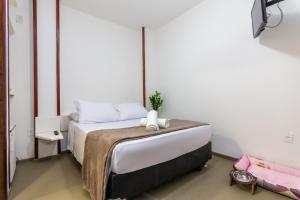 Säng eller sängar i ett rum på Pousada Via Mar Búzios