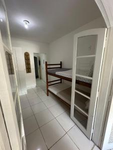 a room with a bed and a tiled floor at Caminho das Pedras Búzios in Búzios